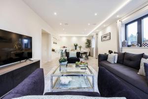 un soggiorno con divano e tavolo di Modern Home in Gerrards Cross With Free Parking By AV Stays a Gerrards Cross