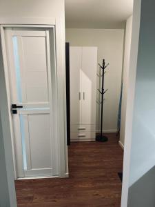 an empty room with a door and a cross at Sun Clock Apartment in Šiauliai