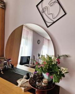 a living room with a table with flowers on it at CozyPlace in Kuldīga