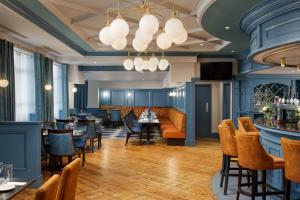 a restaurant with tables and chairs and a bar at Springfield Hotel in Leixlip