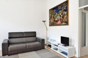 a living room with a couch and a tv at San Giacomo Apartment in Venice