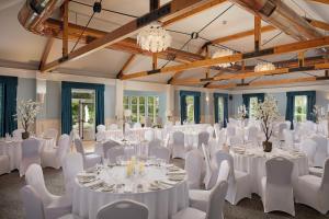 a room with white tables and chairs and a ballroom at Springfield Hotel in Leixlip