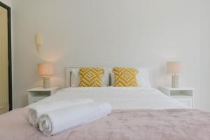 a bedroom with a white bed with two tables at Great Location! Darling Harbour Superb 2BR Apt in Sydney +20 photos