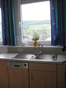 a kitchen counter with a sink and a window at Haus Klara in Detzem