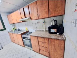 Kuchyň nebo kuchyňský kout v ubytování Corniche AD - Nicely Room