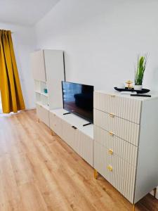a white dresser with a tv on top of it at Joy City Stay Mara M10-12 in Timişoara