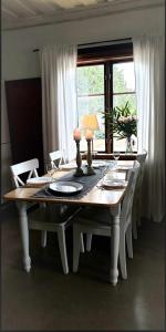 a table with chairs and a lamp on top of it at Årsunda Strandbad Sjösunda vandrarhem in Årsunda