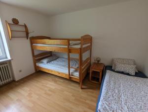 a bedroom with two bunk beds and a bed at Ferienwohnung Am Seebach, 80 Qm in Titisee-Neustadt