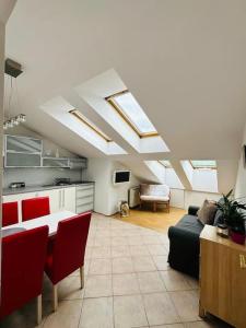 a living room with skylights and a couch and a table at Luna Apartments in Krakow