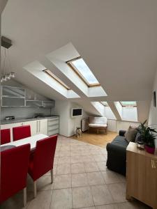 a kitchen with skylights and a living room with a table at Luna Apartments in Krakow