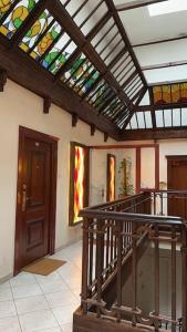 a room with a staircase with a stained glass ceiling at Luna Apartments in Krakow