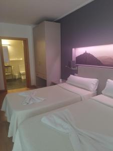 Postel nebo postele na pokoji v ubytování Hello Villarreal Suites