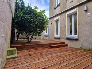 a wooden deck on the side of a building at Appartement Cosy centre-ville in Angers