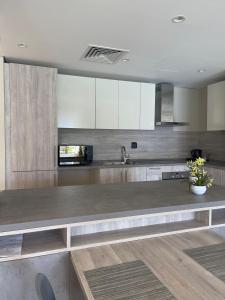 a kitchen with white cabinets and a counter top at Mangroovy Residence El Gouna - Grovin in Hurghada