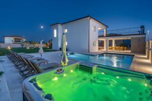 a swimming pool in the backyard of a house at Villa Hugo in Vodnjan +36 photos