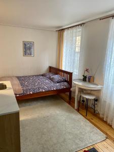 a small bedroom with a bed and a table at 42 Juhkentali in Tallinn