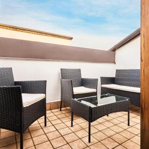 a balcony with chairs and a coffee table at Moscova Charme Apartment in Milan