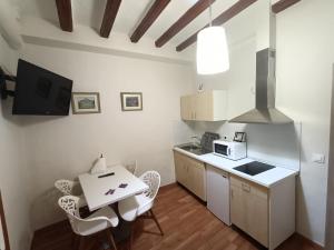 a small kitchen with a table and a microwave at Rey Mundo in Munébrega