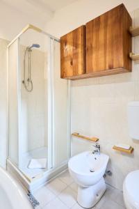 a bathroom with a shower and a toilet and a sink at Moscova Charme Apartment in Milan