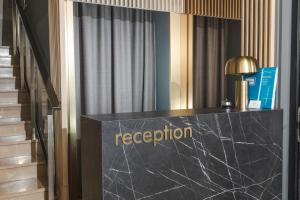 a reception desk with the word reception on it at Hotel 219 Budva in Budva