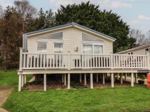 a house with a large deck with a porch at Evergreen Pines in Scarborough