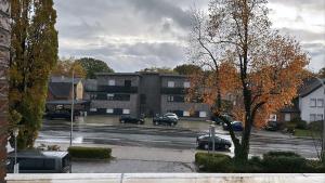 a parking lot with cars parked in front of a building at Beautiful Apartment in Ibbenbüren in Ibbenbüren