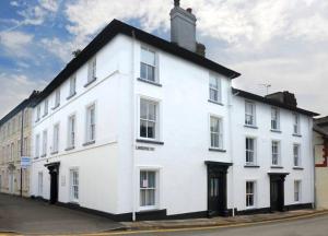 a white building on the side of a street at Ty Helyg Guest House in Brecon
