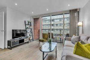 a living room with a couch and a tv at Clerkenwell Serviced Apartment by MySquare in London