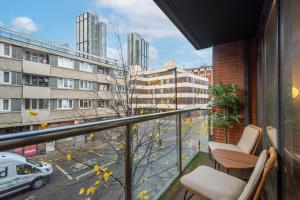 a balcony with chairs and a view of a city at Clerkenwell Serviced Apartment by MySquare in London