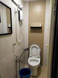 a small bathroom with a toilet and a phone at Homestay Manitha in Seri Manjung