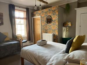 a bedroom with a large bed and a window at Kelston Guest House in Weymouth
