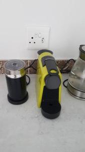 a yellow and black appliance sitting on a counter at Delightful db story loft with airconditioning in Hermanus