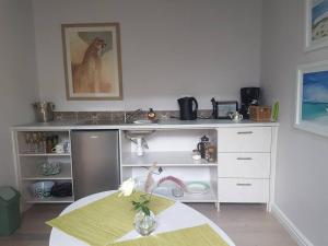 a kitchen with a table and a dog on the counter at Delightful db story loft with airconditioning in Hermanus