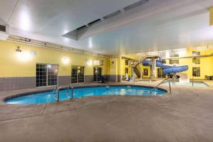 a large pool with a slide in a building at Ramada by Wyndham Spokane Airport in Spokane +80 photos