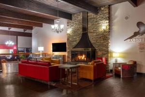 a living room with a couch and a fireplace at Ramada by Wyndham Spokane Airport in Spokane