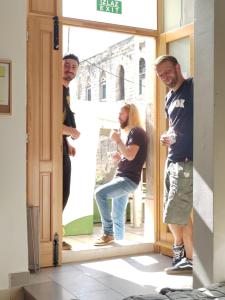 a group of people standing inside of a doorway at Split It Hostel in Split