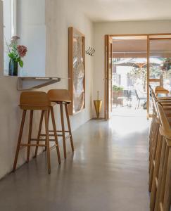 a kitchen with stools and a counter with a view of a patio at BAR10ZIMMER in Dornbirn +45 photos