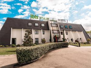 a building with a sign on top of it at Ibis Styles Toulouse Labège in Labège