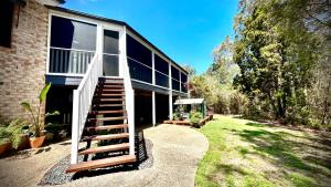 a house with a staircase leading up to it at Perfect North Brisbane Retreat 4 bed in Griffin