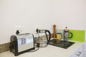 a kitchen counter with a toaster and a toaster oven at Delightful db story loft with airconditioning in Hermanus
