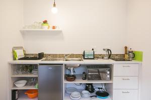 a kitchen with a sink and a counter top at Delightful db story loft with airconditioning in Hermanus