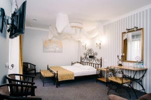 Ένα ή περισσότερα κρεβάτια σε δωμάτιο στο SPA-Hotel Dodo +74 φωτογραφίες