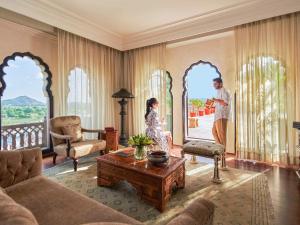 a man and a woman standing in a living room at Fairmont Jaipur in Jaipur
