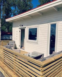 a wooden deck in front of a house at Frykenbadens Camping in Kil