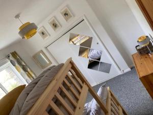 a room with a bunk bed and a mirror at The Lower Hymnary in Haverfordwest