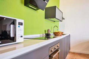 a kitchen with a counter with a microwave at Tenuta di Megognano in Poggibonsi