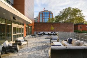 a patio with couches and chairs on a building at Hyatt Place Albany in Albany