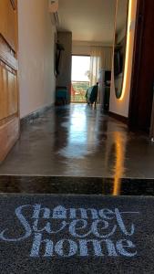 a hallway with a sign that says slow down on the floor at Flats Baia dos Porcos in Fernando de Noronha