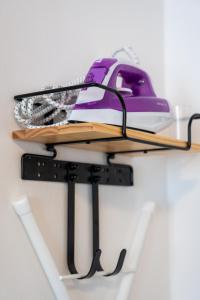 a shelf with a purple phone on it at Volante Studio Bremen-Findorff in Bremen