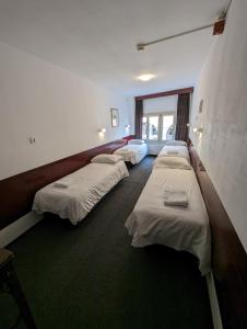 a row of beds in a room with at Budget Hotel Ben in Amsterdam